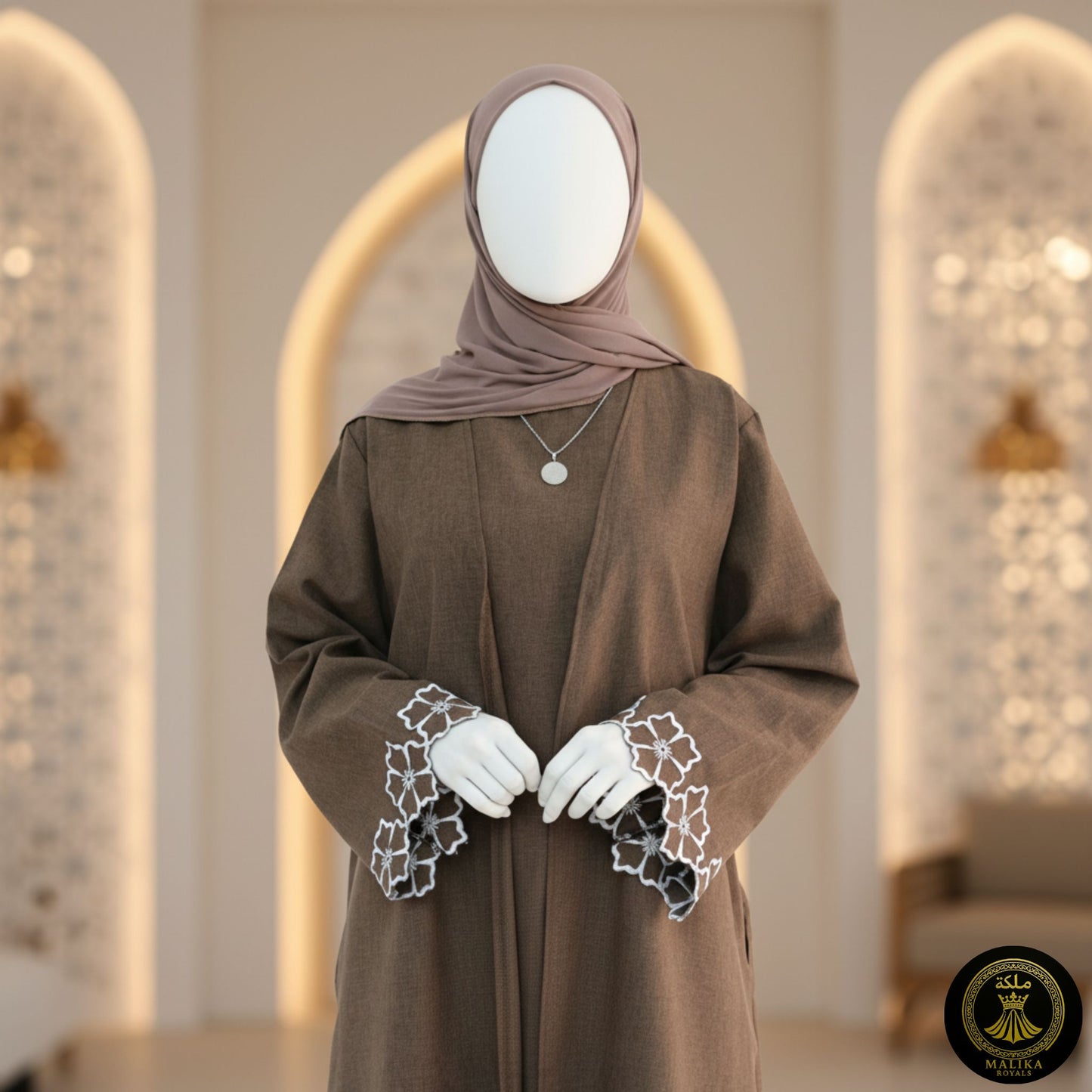 Person wearing a lux brown abaya with lace cuffs and embroidery