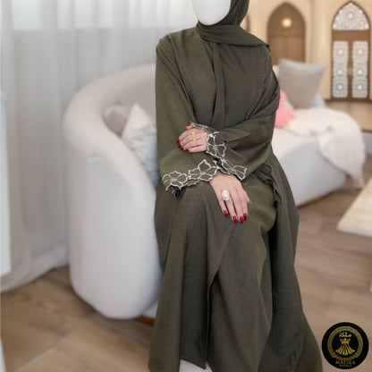 Woman wearing an elegant olive green abaya with intricate sleeves