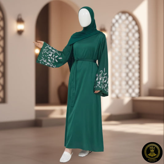 Green dress with floral patterns on a mannequin against an architectural background