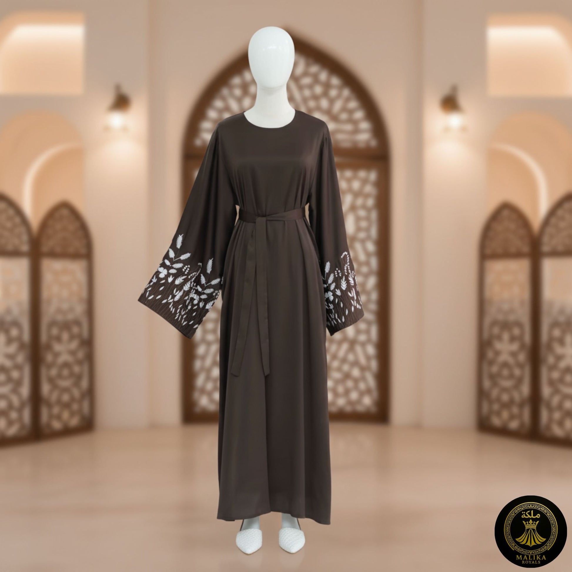 Coffee dress with lace sleeves on a mannequin against an architectural background